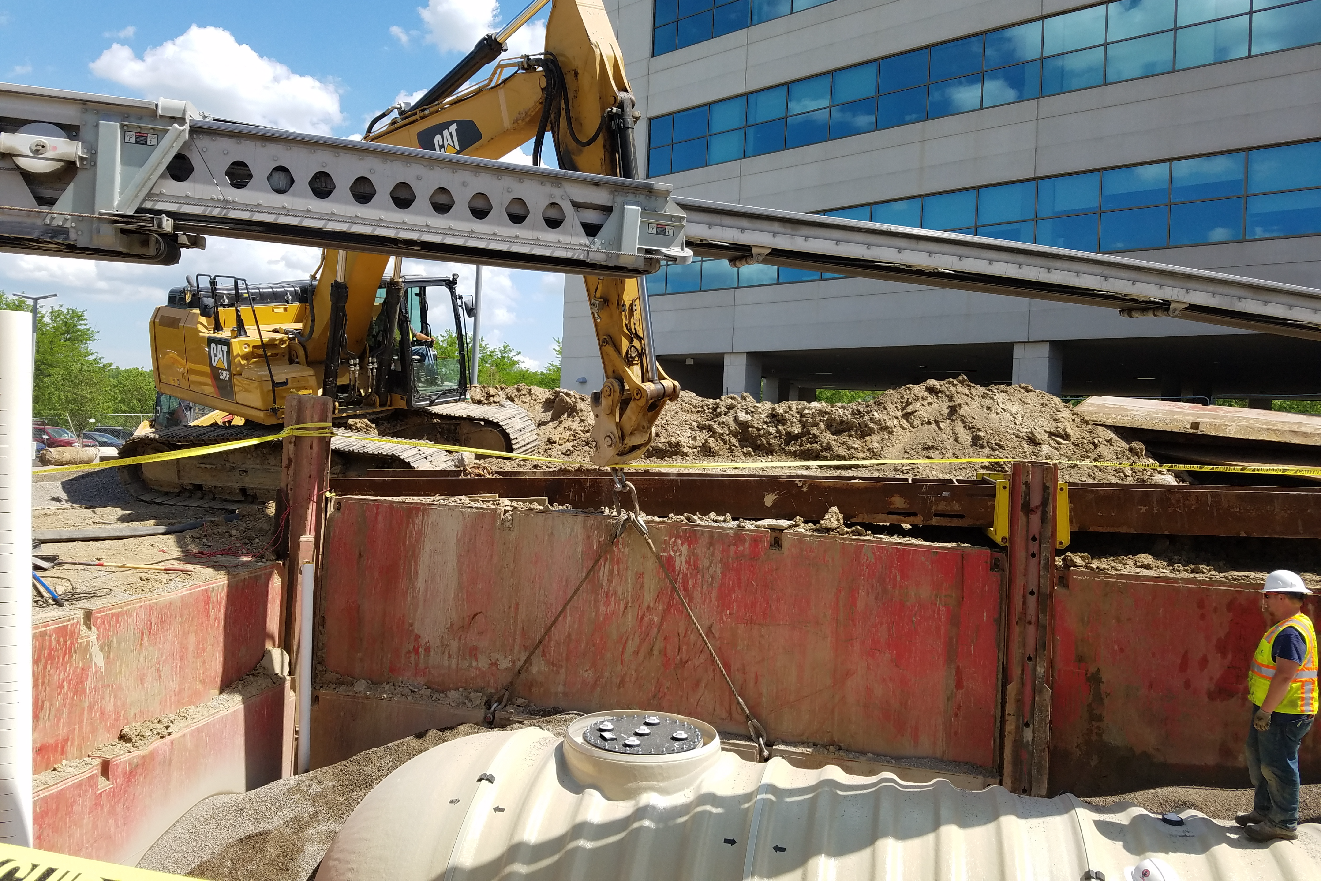 tank being pulled out by a crane from underground